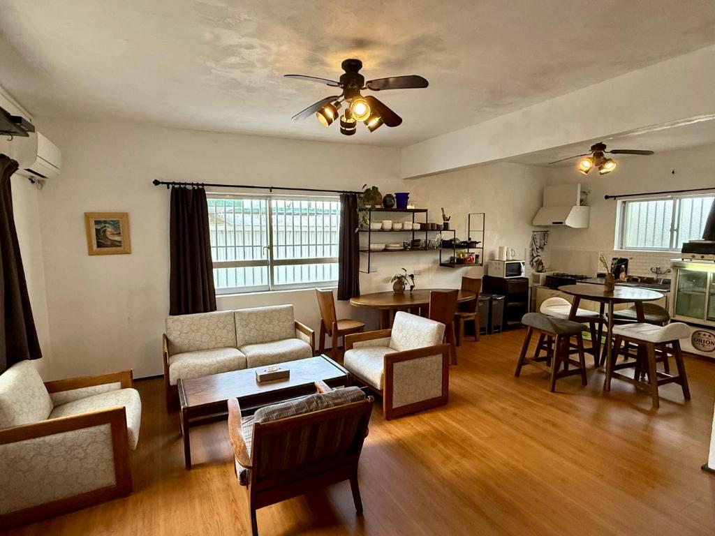 a living room with a couch and chairs and a table at P-house Yumearu in Sobe