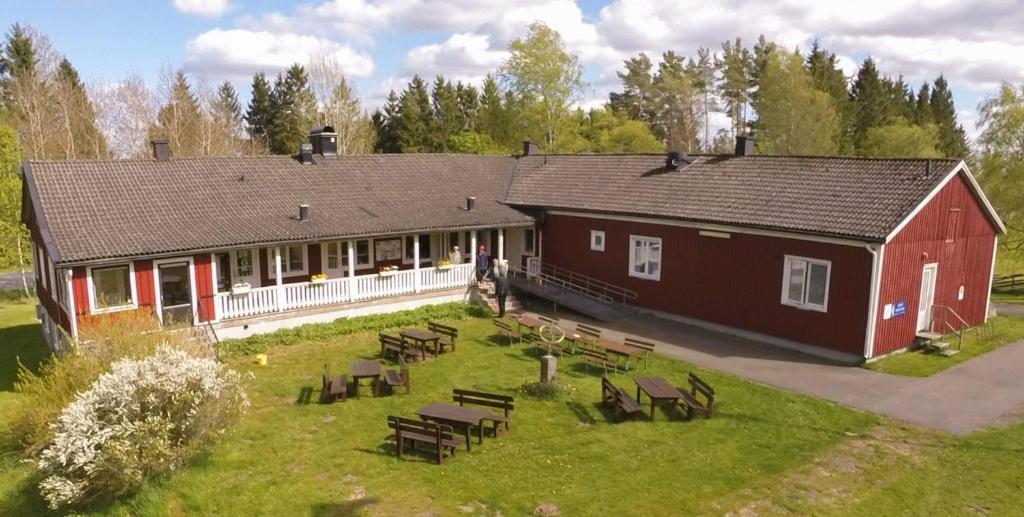 an aerial view of a barn with tables and chairs at Kronobergshed vandrarhem och kursgård in Moheda