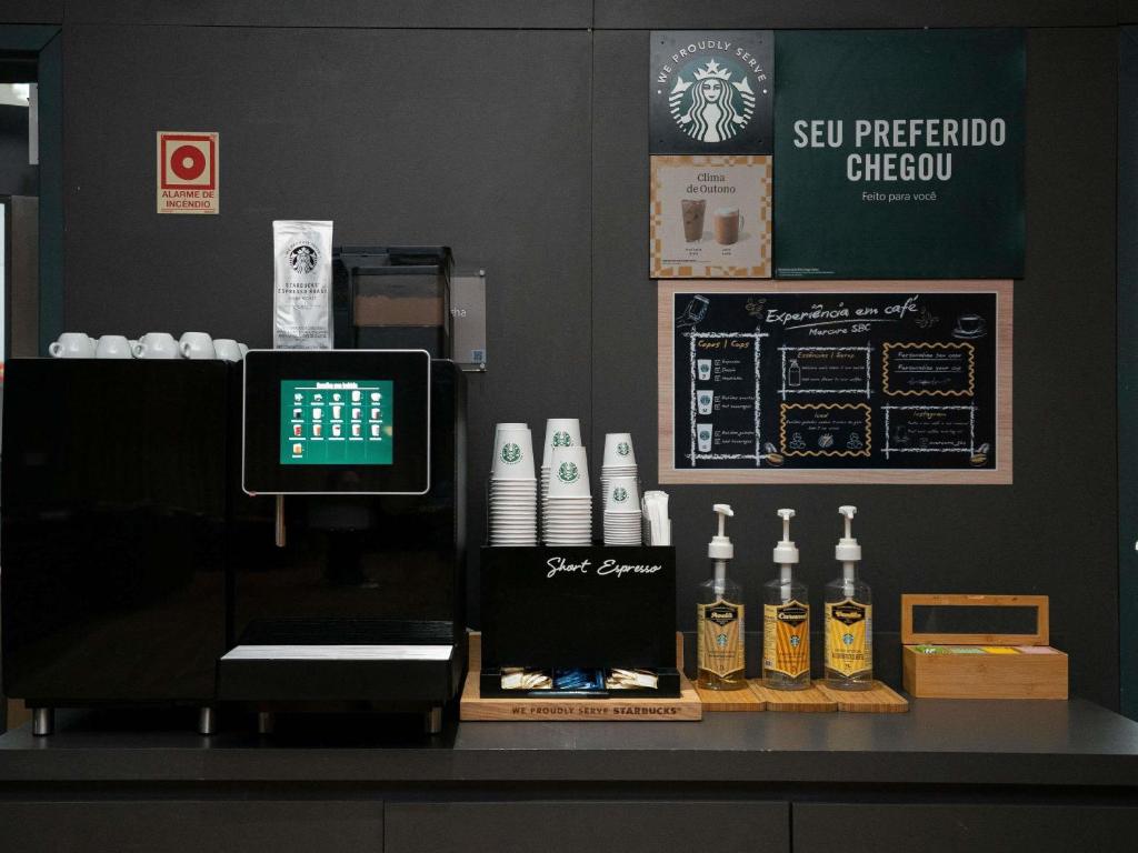a counter with bottles of alcohol on top of it at Mercure Sao Bernardo Do Campo in São Bernardo do Campo