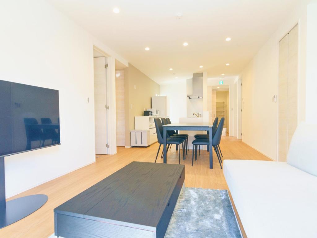 a living room with a table and chairs at Burikina Terrace in Nago