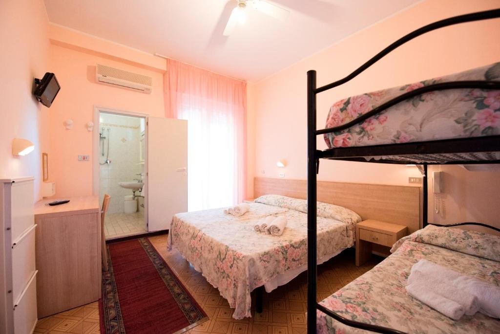 Postel nebo postele na pokoji v ubytování Hotel Settebello B&B
