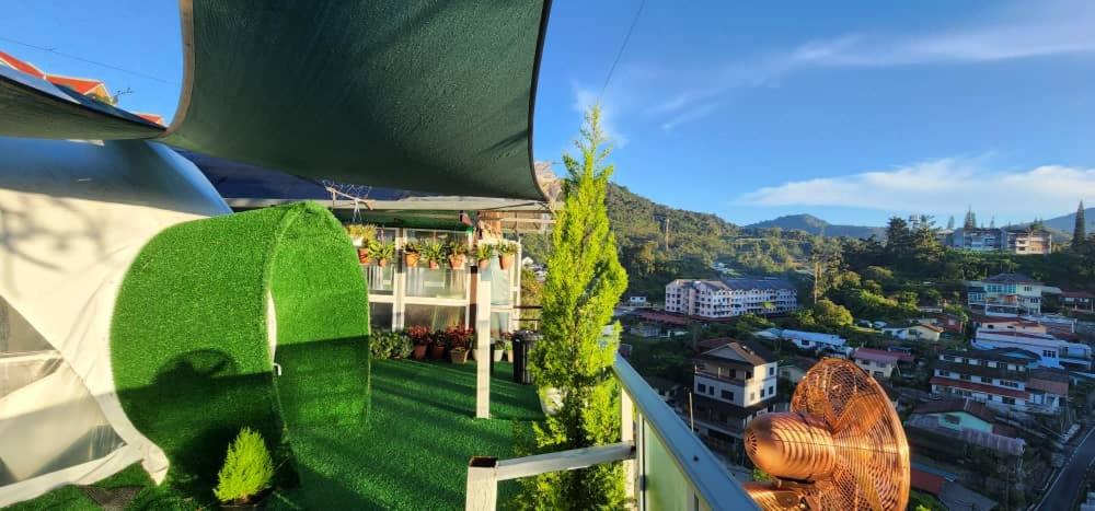 a view from the balcony of a building with green grass at Sameer Mountain View Glamping in Cameron Highlands