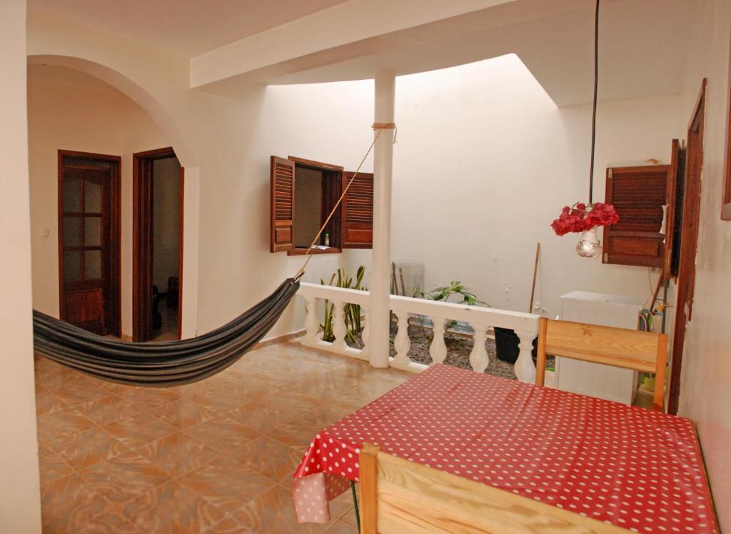 a room with a hammock in a house at Private Holiday Apartment in Tarrafal