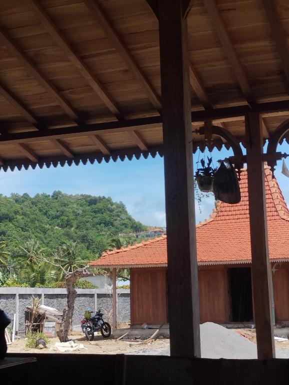 a view of a house with a motorcycle parked outside at Dooz's place - Selong belanak in Selong Belanak