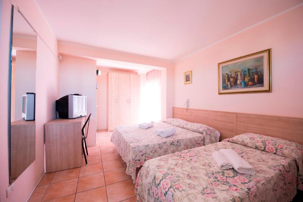 Postel nebo postele na pokoji v ubytování Hotel Settebello B&B