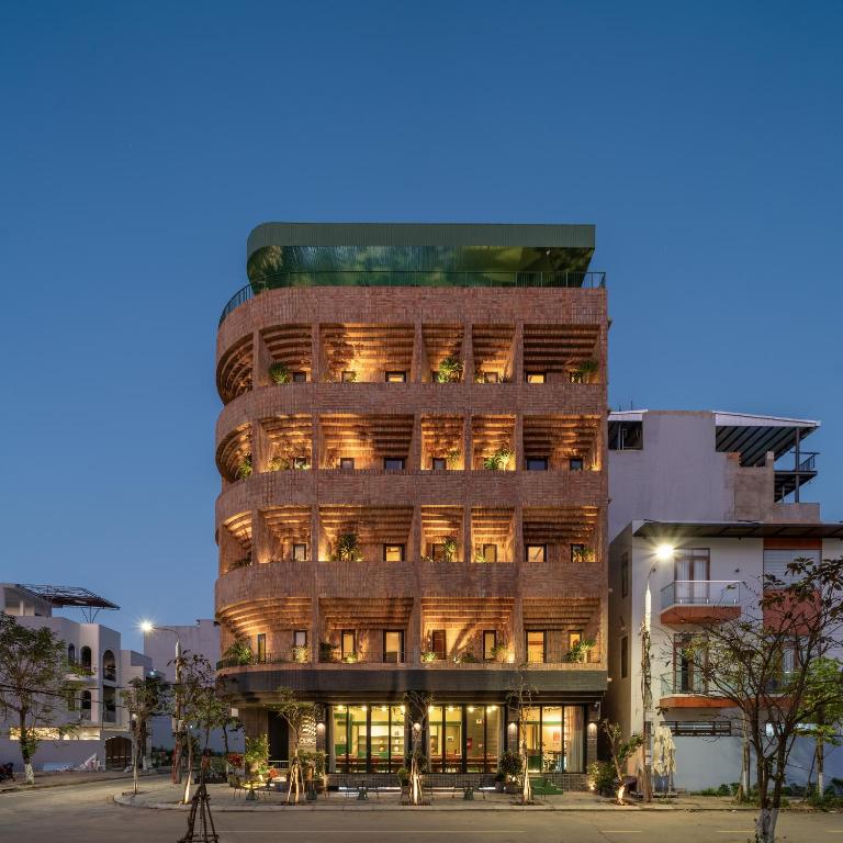 a tall building with many windows at dusk at Olwen Boutique Hotel in Danang
