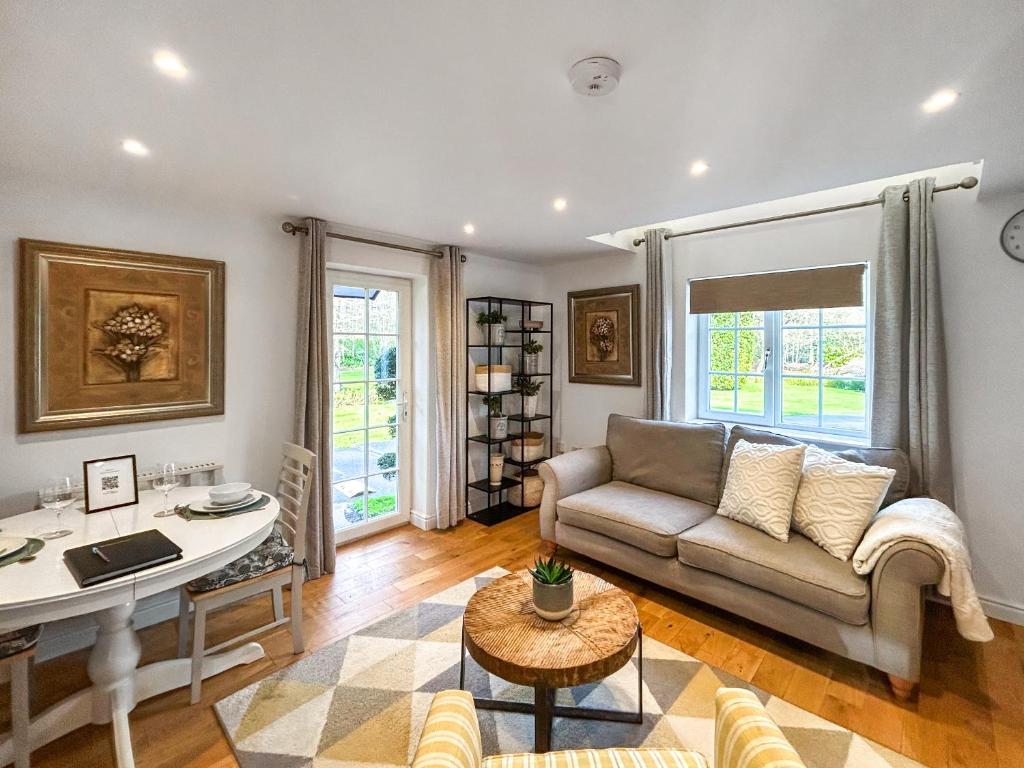 a living room with a couch and a table at Eagles Nest in Guildford