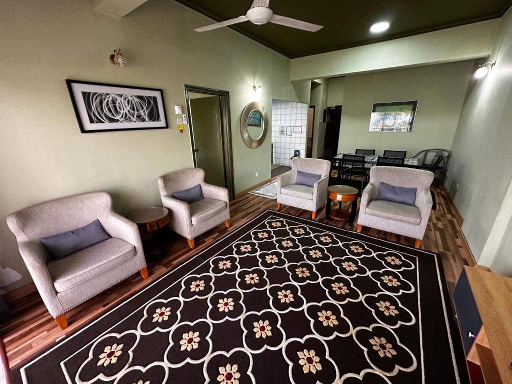 an open living room with chairs and a rug at The Regency PortDickson A1-7 in Port Dickson