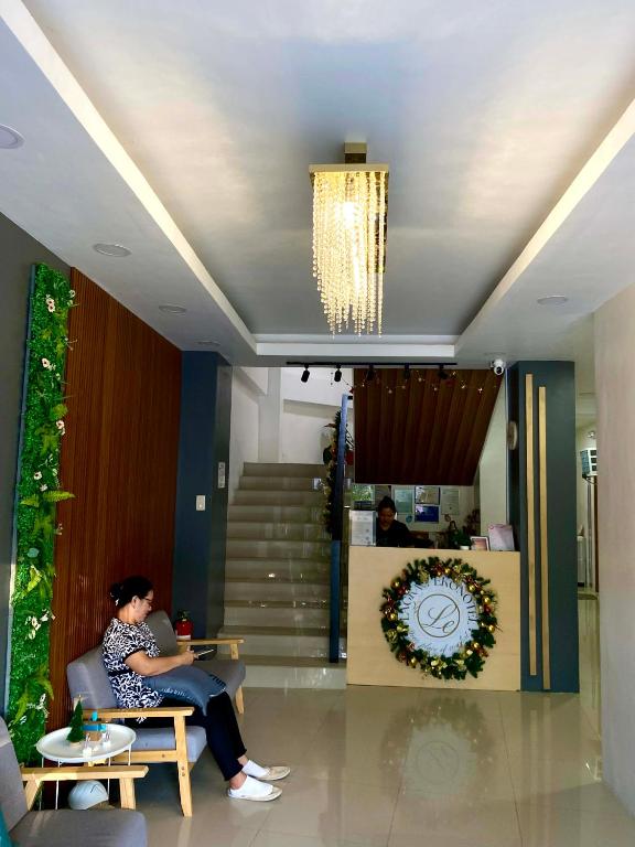 a woman sitting on a chair in a lobby at Lagkaw Ekonotel in Dipolog