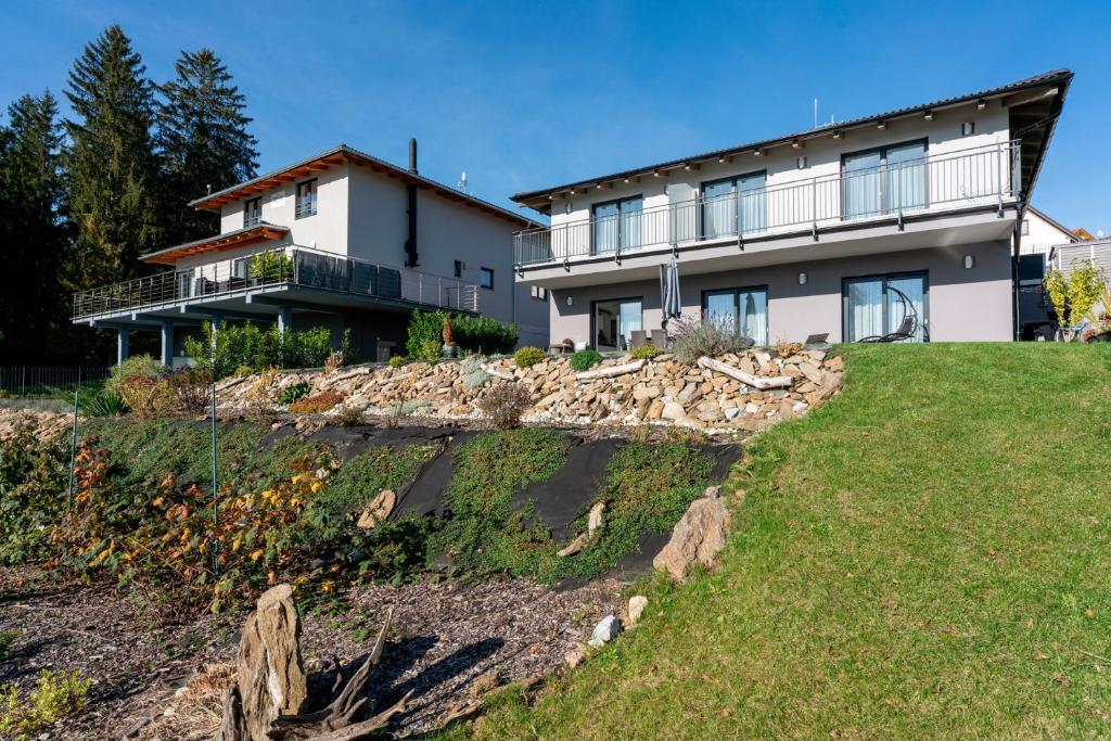 a house on a hill with a pile of rocks at Apartmány Sunny hill in Frymburk