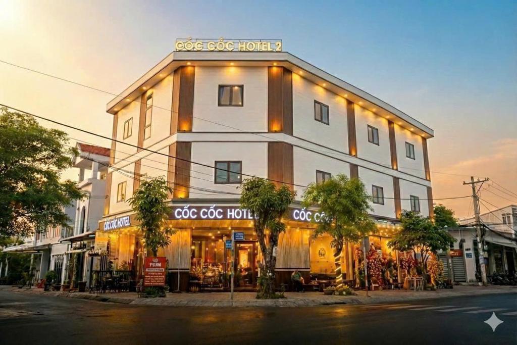 a building with a store on the side of a street at Hotel Cốc Cốc 2 in Ấp Rạch Mẹo