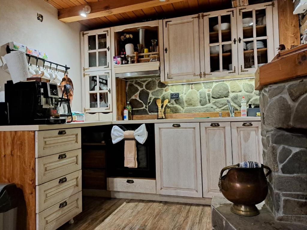 a kitchen with white cabinets and a sink at River Garden in Beli Osŭm