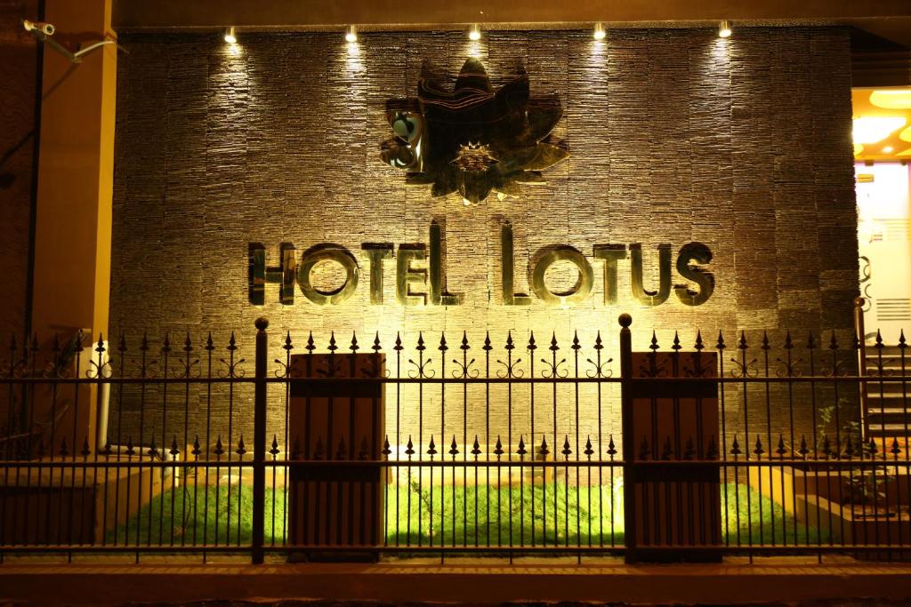 a hotel lotus sign on the side of a brick building at Hotel Lotus in Madurai
