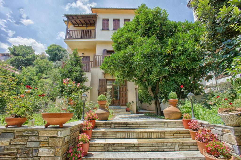 a house with a garden with stairs and plants at Melifilos in Agios Ioannis Pelio
