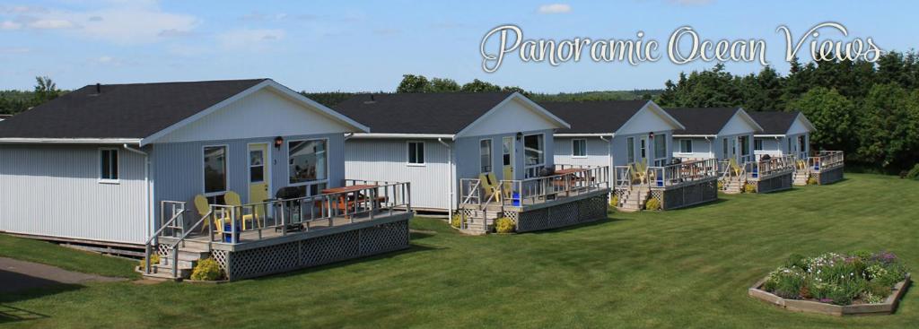a row of modular homes in a yard at Cavendish Bosom Buddies Cottage Resort in Cavendish