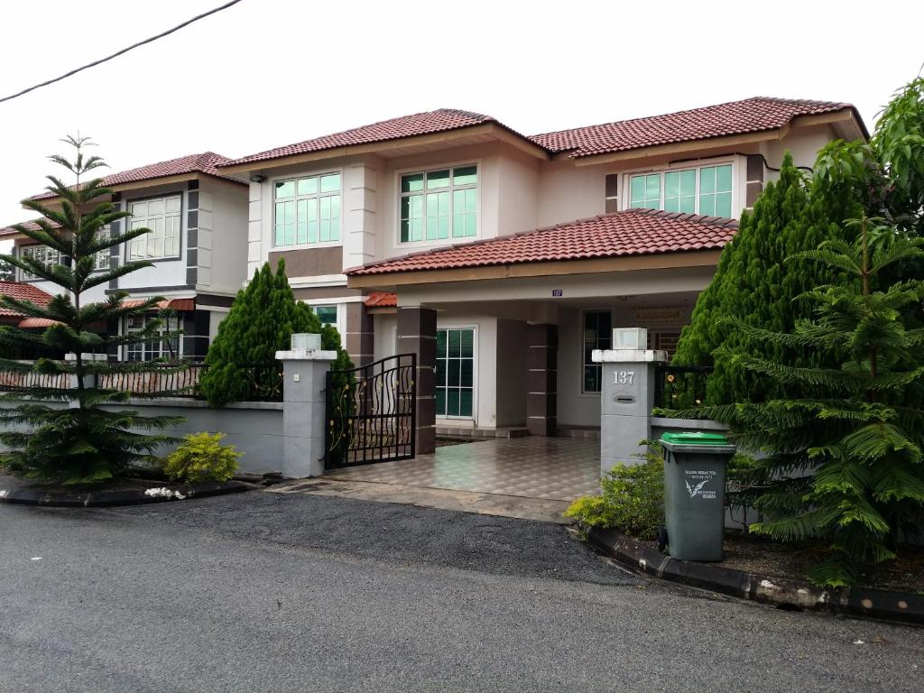 a house with a gate in front of it at The Louvre Moslim Homestay Sungai Petani in Sungai Petani