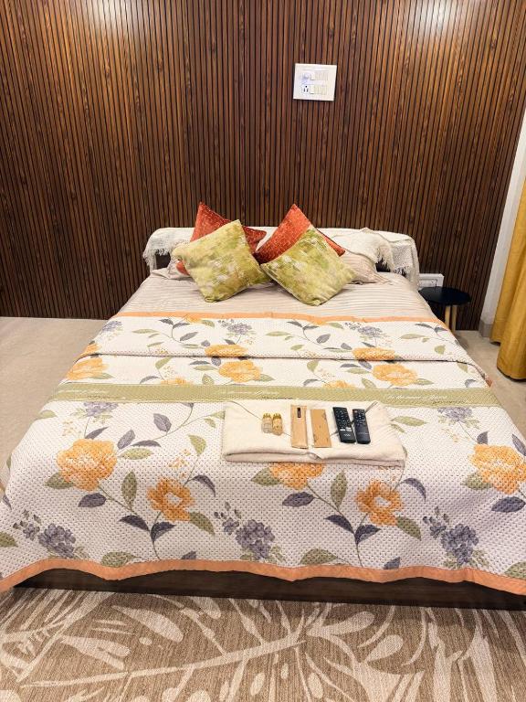 a large bed with a blanket and pillows on it at Mihira Homestays in Hanamkonda