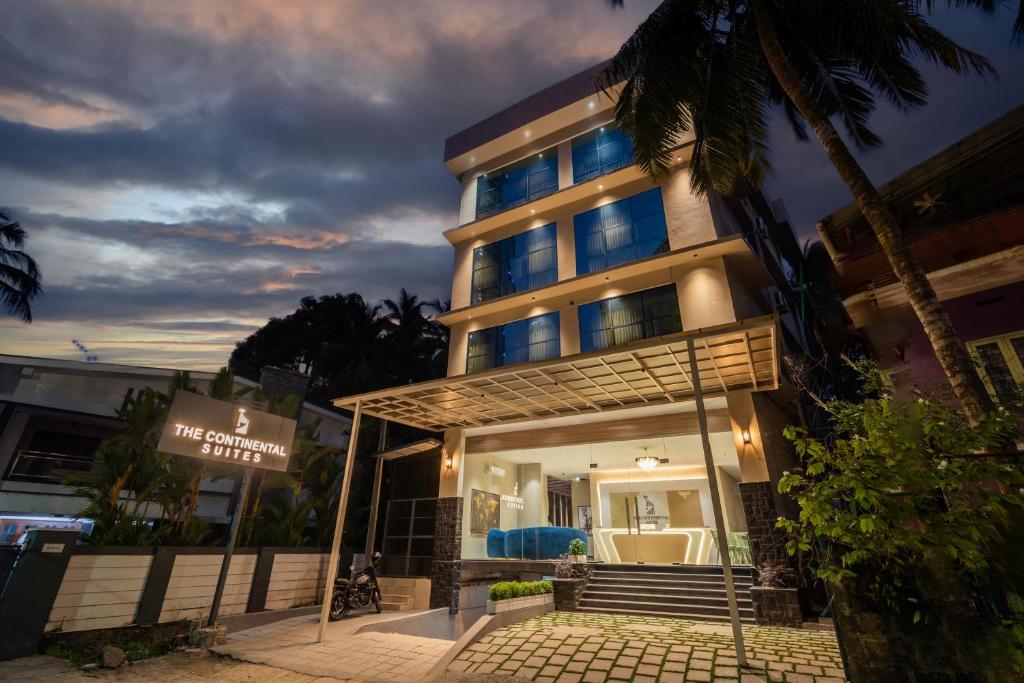 a building with a sign in front of it at The Continental Suites in Kozhikode