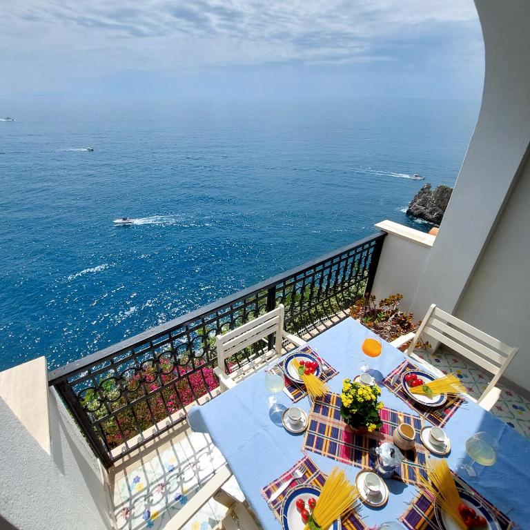 a balcony with a table with a view of the ocean at Casa Gianna New 2026 in Praiano