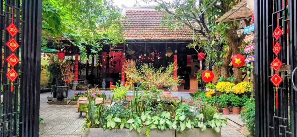 a garden center with a bunch of flowers in a doorway at Trầm Homestay in Thôn An Hòa
