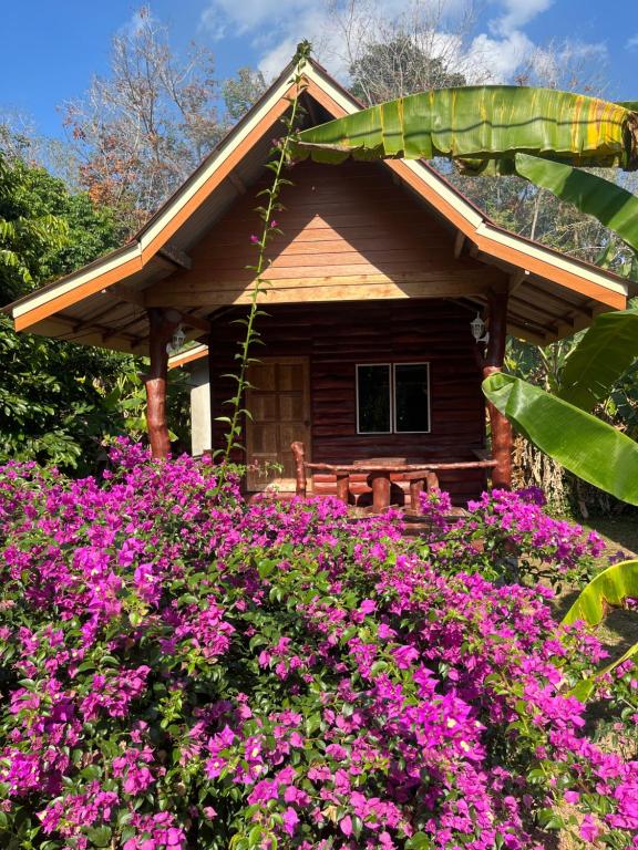 a house with pink flowers in front of it at Koh Jum Ozone Resort in Ko Jum