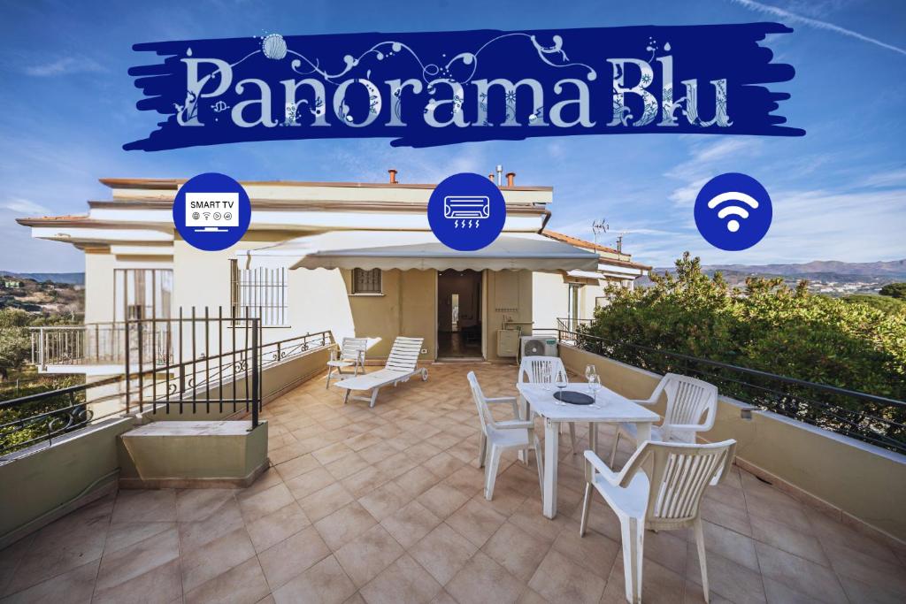a patio with white chairs and a table on a balcony at Panorama Blu - Spiaggia 7min - Terrazza - WiFi in Celle Ligure