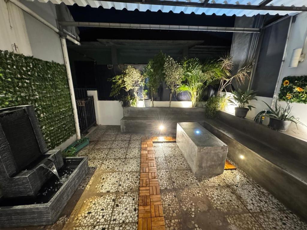 a patio with a couch and some plants at Lamar home in Jakarta