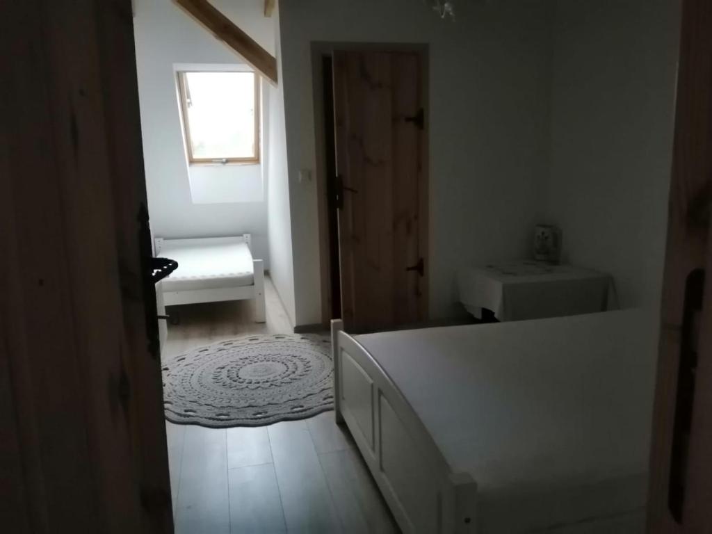 a white bathroom with a sink and a toilet at Izdebka in Bochowo