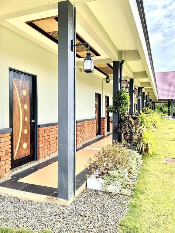 a building with a door with a sign on it at Papalu Villa in Kuala Penyu