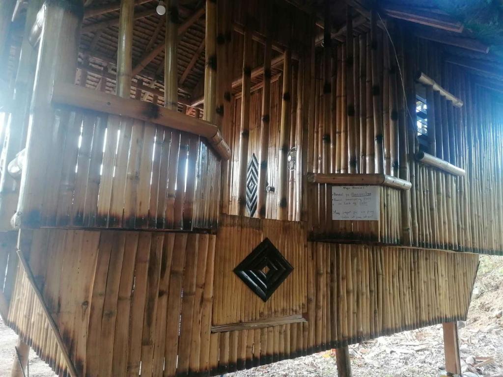 a building made of bamboo with a plaque on it at Rendan Kubo in Batangas City