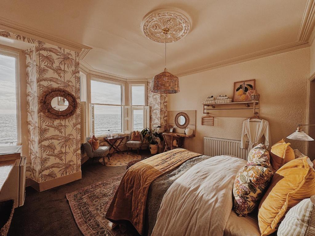 a bedroom with a bed and a large window at Môr Heli Guest House Criccieth in Criccieth