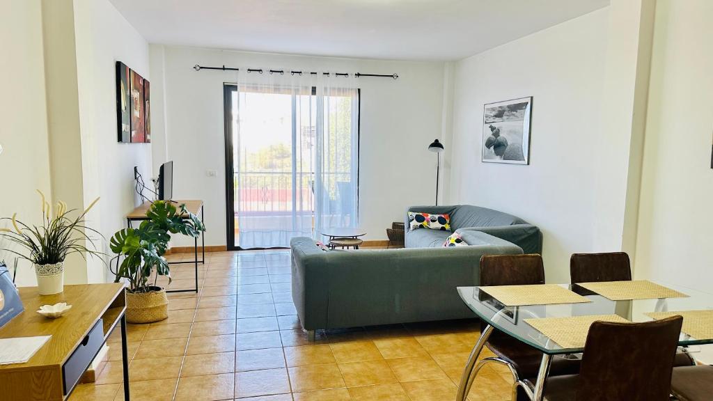 a living room with a couch and a table at Apartamentos Ajabo Adeje in Adeje