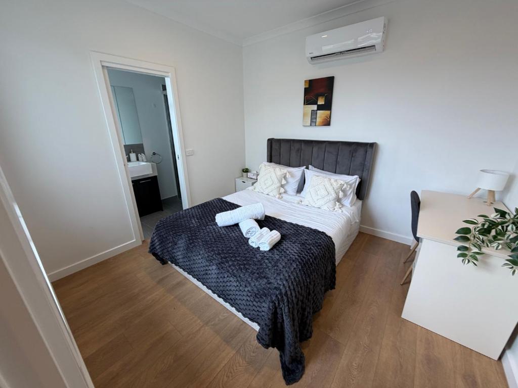 a bedroom with a bed with two towels on it at Monash Ensuite room with shared kitchen & laundry in Oakleigh East