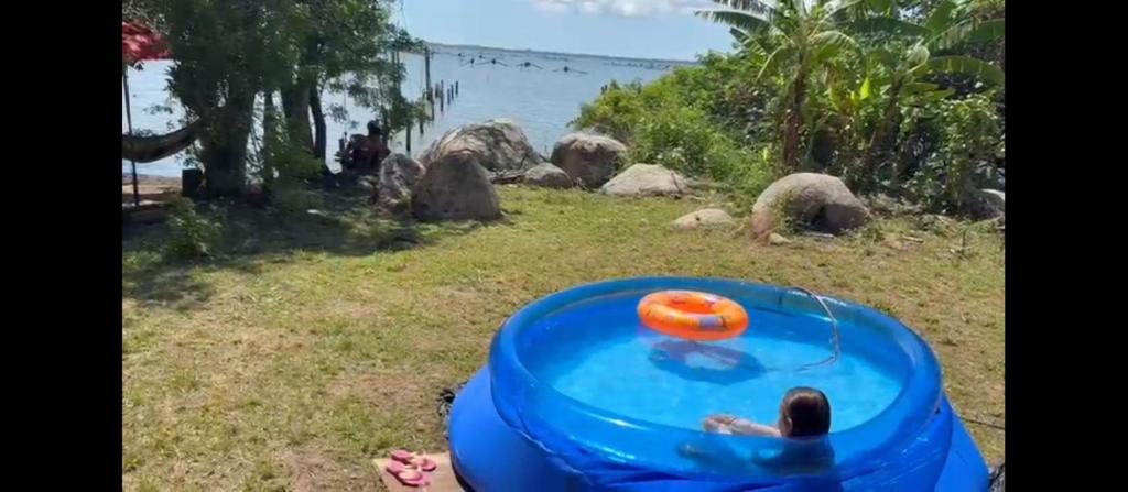 a person is playing with a frisbee in the water at Casa da Lagoa perto do Mar in Pescaria Brava
