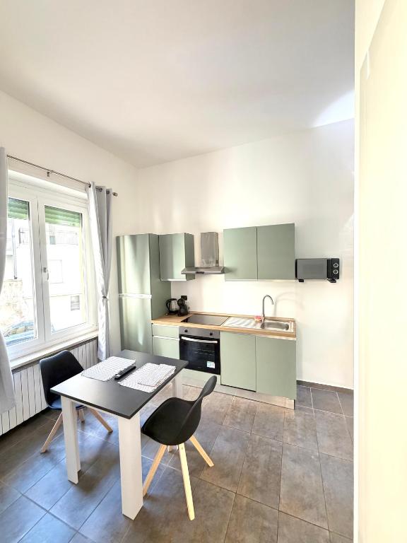 a kitchen with a table and chairs in a room at Cavour 16 Biella Studio Centro in Biella