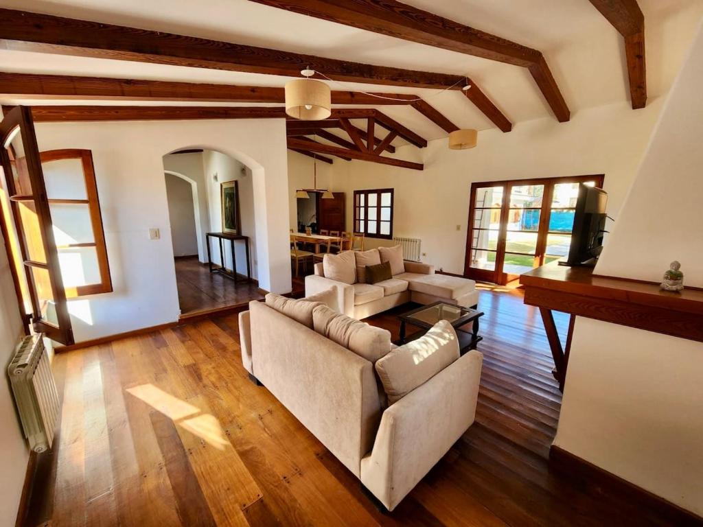 a living room with a couch and a table at Estancia Bogotá in Ciudad Lujan de Cuyo