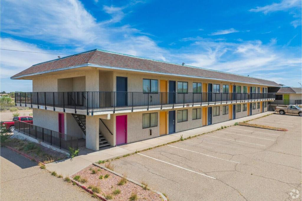 a building with colorful windows and a parking lot at Gazelle Stay by Hotel O Socorro in Socorro