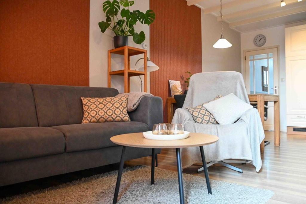 a living room with a couch and a table at Zilte zee Ameland in Buren