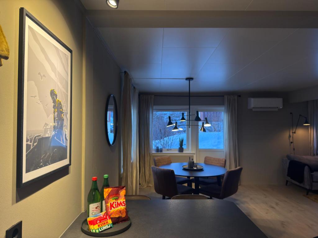 a living room with a table and a dining room at Fishermans Villa Ballstad - Lofoten in Ballstad