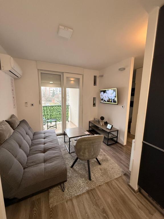a living room with a couch and a table at Perfect Place 32 in Varaždin