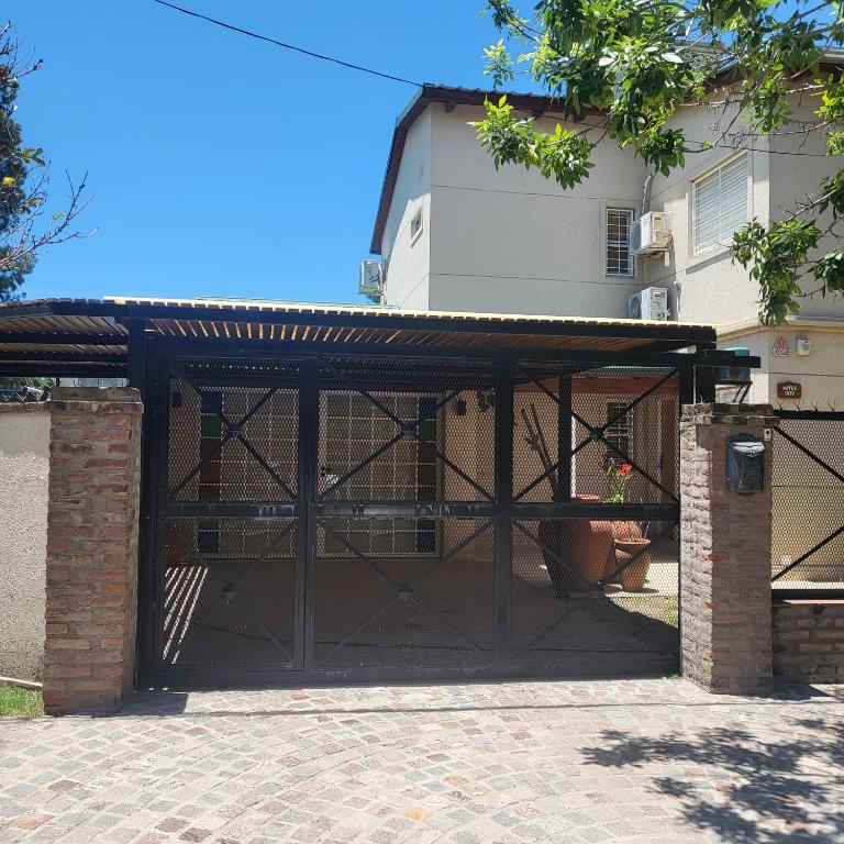 a garage with an open door in front of a house at Miranda House in Estancia San Ramon