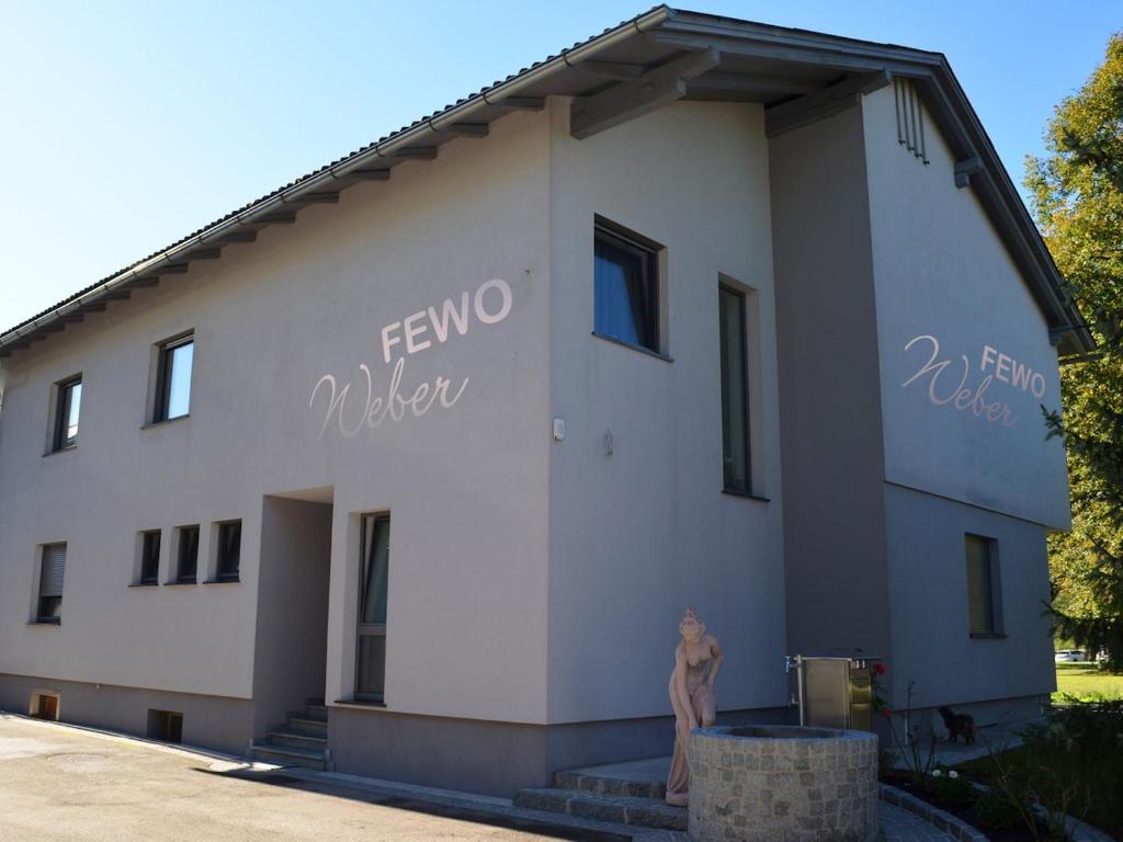 a building with a statue in front of it at FEWO Weber in Lukowitz