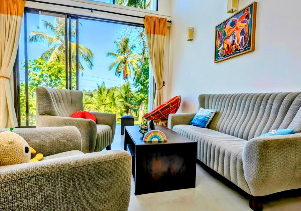 a living room with two couches and a table at Tranquil Heaven Near Galle & Unawatuna Quiet Stay & Fast WiFi in Galle