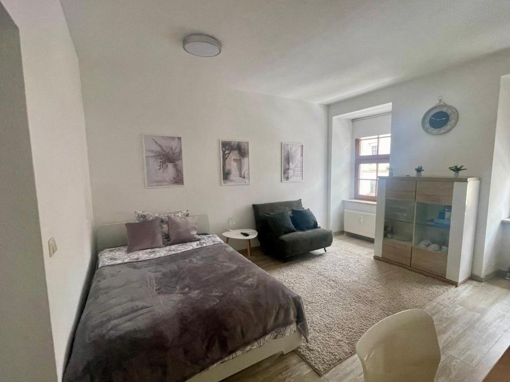 a bedroom with a large bed and a couch at Bike & Relax in Bernburg