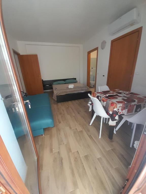 a view of a living room with a table and chairs at Monlocale al 20m del mare con terrazza privata in Roseto degli Abruzzi