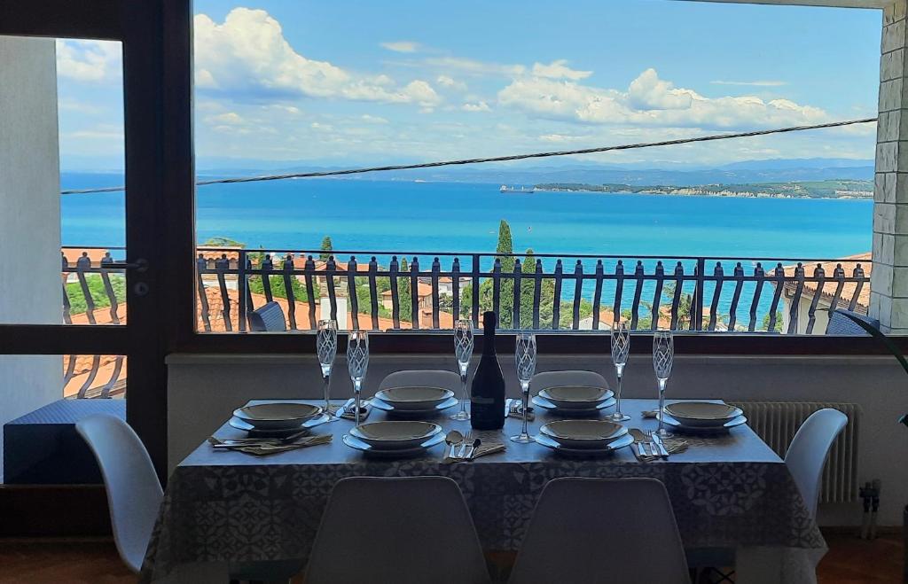 a table with a view of the ocean from a balcony at Apartma Seaside in Koper