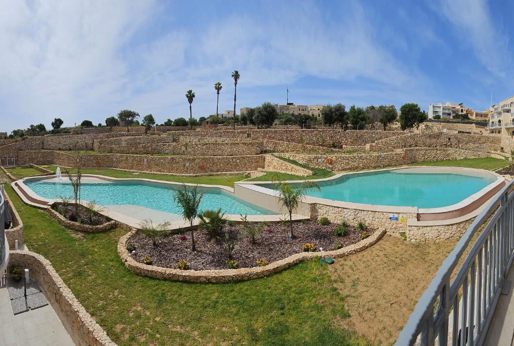 an overhead view of two pools in a park at Hal Wardija - Gozo Hideaways in Qala