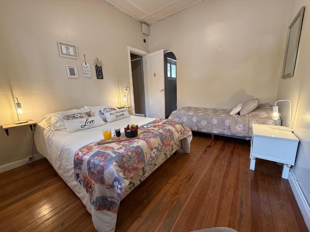 a bedroom with two beds and a table with drinks on it at Amplia casa en la 5ta sección ciudad con patio y parrilla in Mendoza