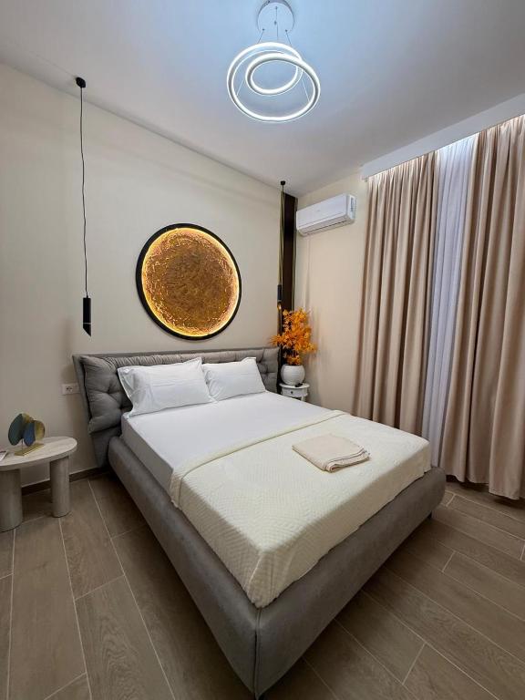 a bedroom with a large bed in a room at Jera Rooms in Durrës