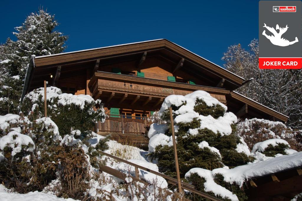 a log cabin in the snow with snow on trees at Chalet Glemm Alpin in Saalbach-Hinterglemm